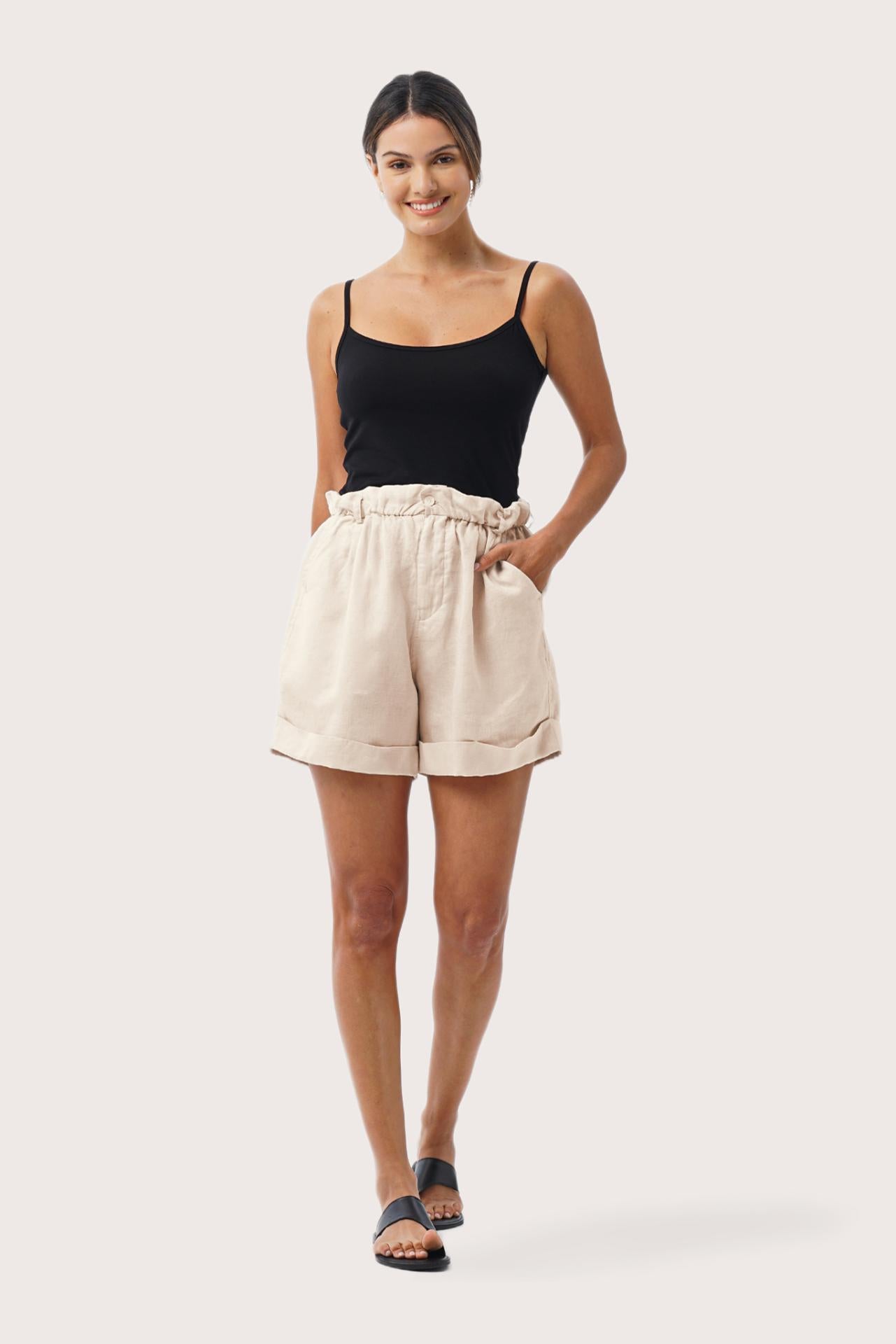 Woman wearing the Taloo Linen Bermuda Crema designed for effortless resortwear and tropical living by By The Sea Bali