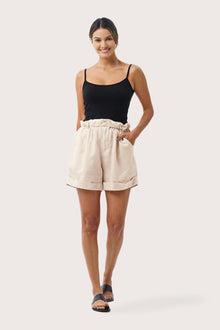 Woman wearing the Taloo Linen Bermuda Crema designed for effortless resortwear and tropical living by By The Sea Bali