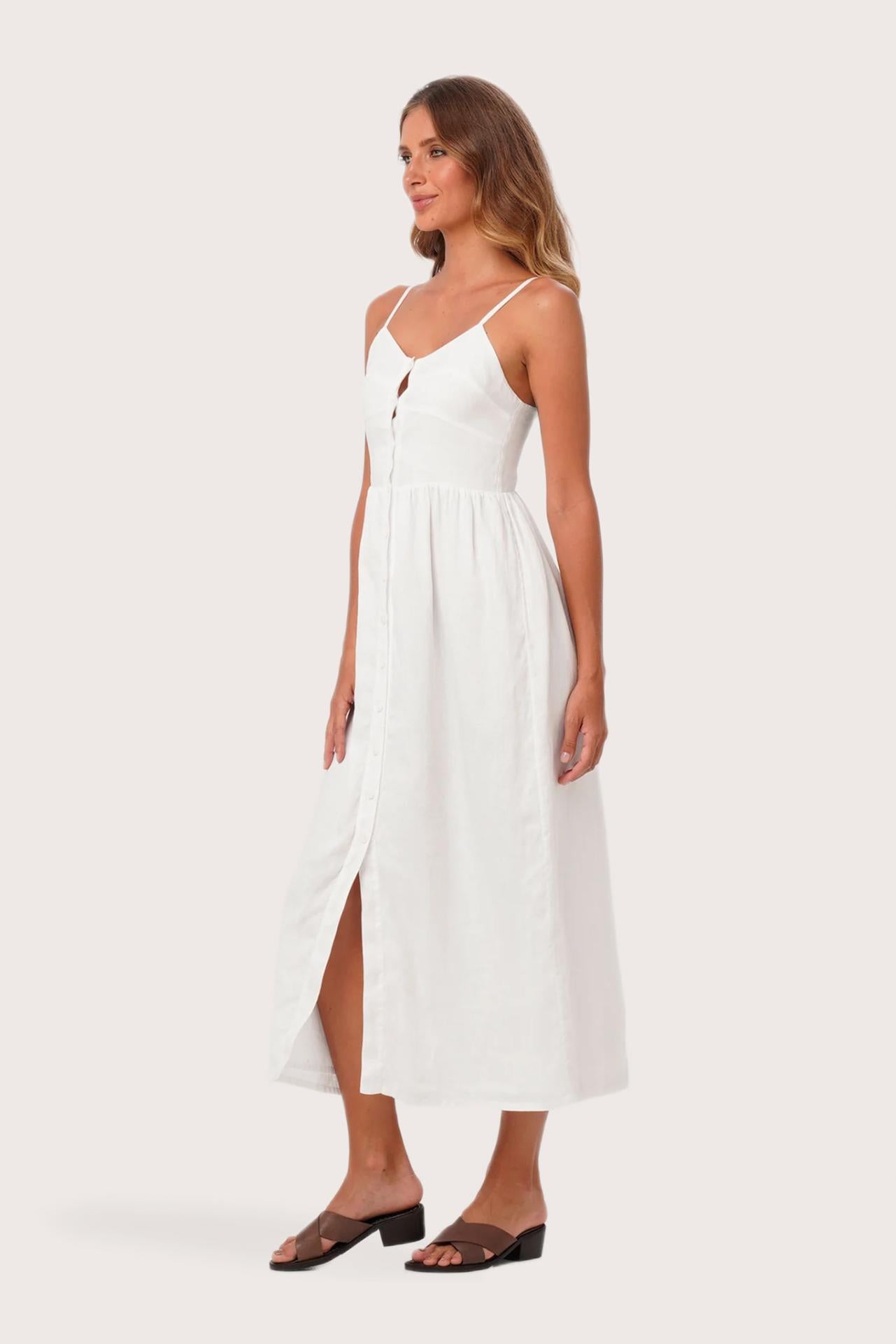 Side profile of the Tarum Linen Dress White showing its cut and natural movement