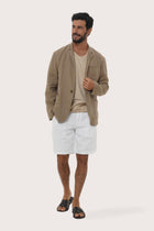 Side profile of the brown linen blazer showcasing its comfortable fit and refined tailoring
