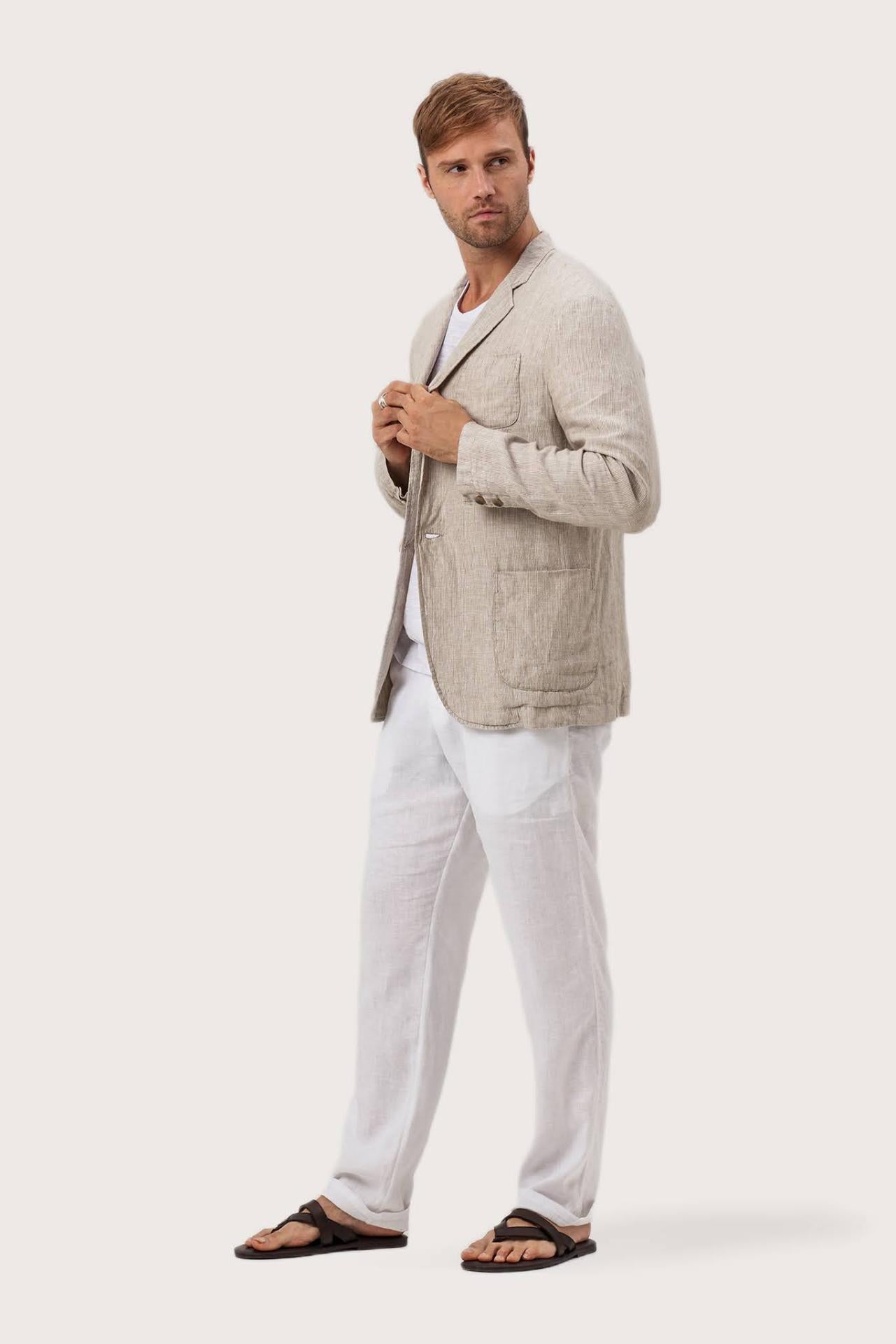 Side profile of the crema linen jacket showcasing its comfortable fit and effortless drape