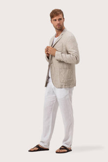 Side profile of the crema linen jacket showcasing its comfortable fit and effortless drape