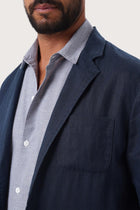 Close-up of the linen fabric texture and refined tailoring details on the La Brisa jacket