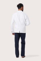 Back view of the white linen jacket with a relaxed and contemporary silhouette