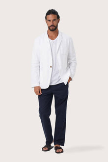 Model wearing the white linen Tenggara jacket by By The Sea Bali