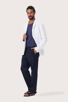 Side profile of the white linen jacket showcasing its comfortable fit and effortless drape
