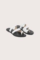 Terra sandal in white and black front view showcasing elegant straps and minimalist resort aesthetic