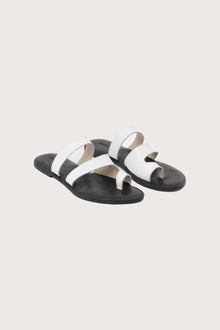 Terra sandal in white and black front view showcasing elegant straps and minimalist resort aesthetic