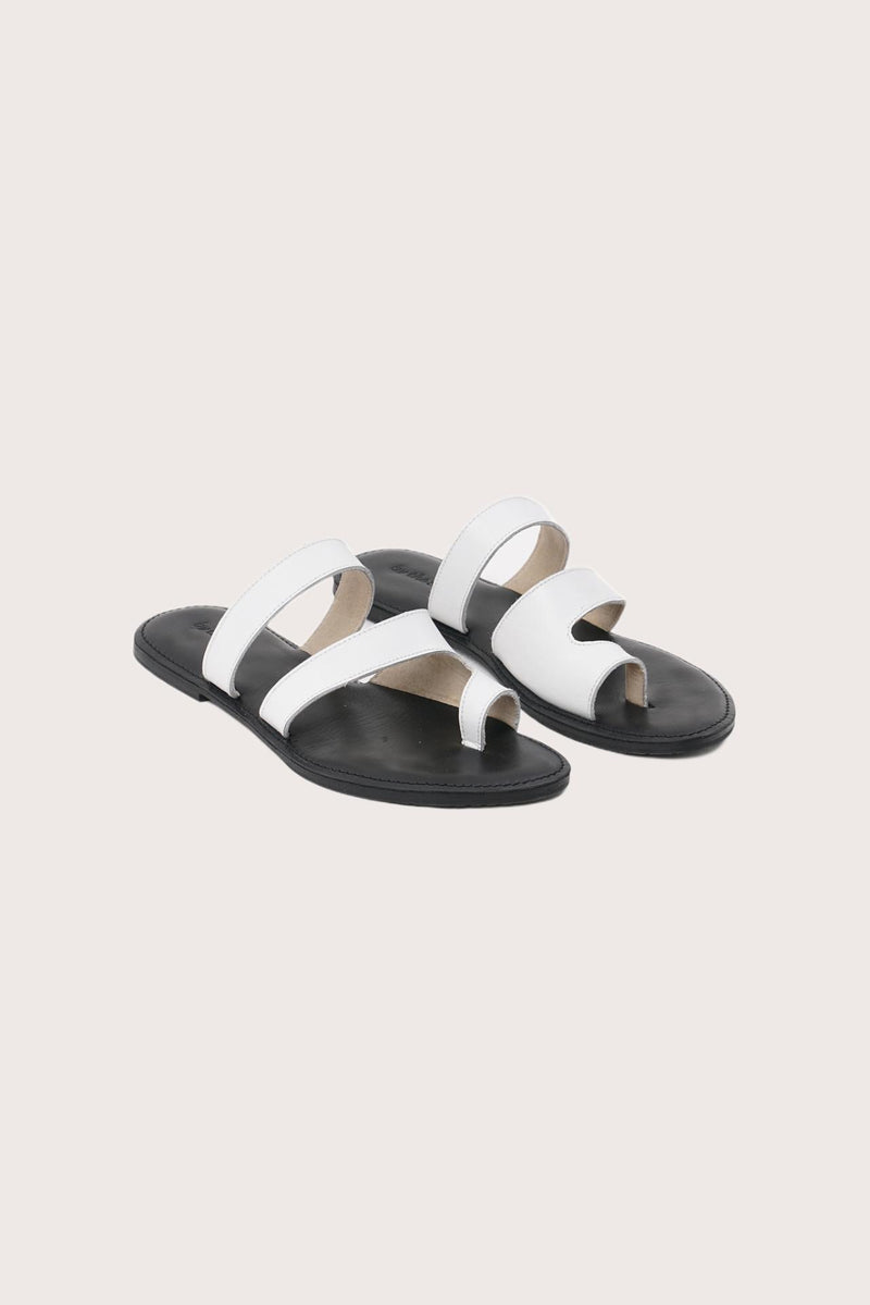 Terra sandal in white and black front view showcasing elegant straps and minimalist resort aesthetic