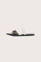 Side profile of Terra sandal in white and black highlighting sleek and modern resort footwear silhouette