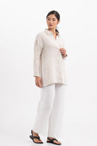 Side profile of the Tifa Linen Shirt Creme showing its cut and natural movement.