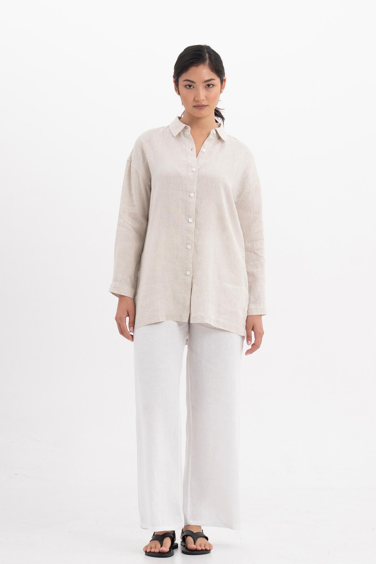 Woman wearing the Tifa Linen Shirt Creme designed for effortless resortwear and tropical living by By The Sea Bali.
