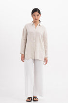 Woman wearing the Tifa Linen Shirt Creme designed for effortless resortwear and tropical living by By The Sea Bali.