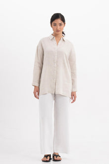 Woman wearing the Tifa Linen Shirt Creme designed for effortless resortwear and tropical living by By The Sea Bali.