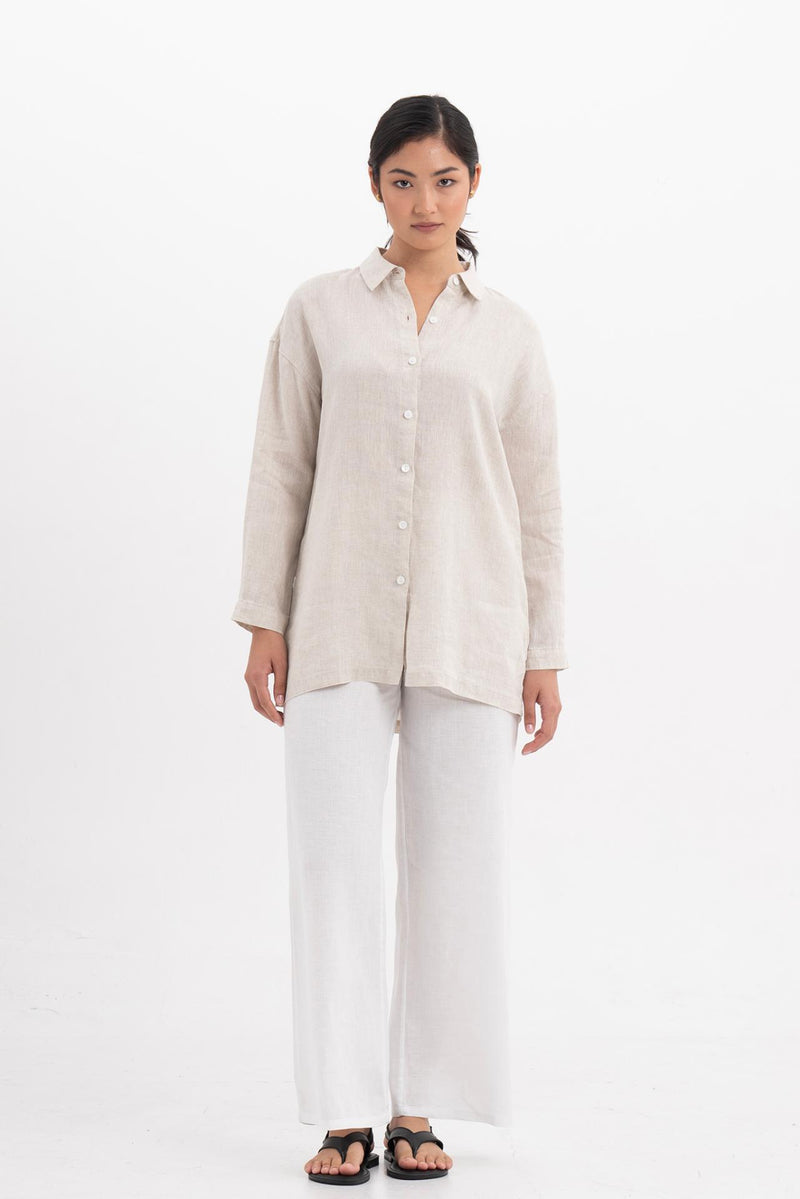 Woman wearing the Tifa Linen Shirt Creme designed for effortless resortwear and tropical living by By The Sea Bali.