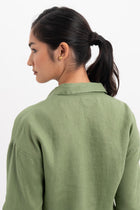 Back view detail of the Tifa Linen Shirt Green highlighting the garment shape and drape.