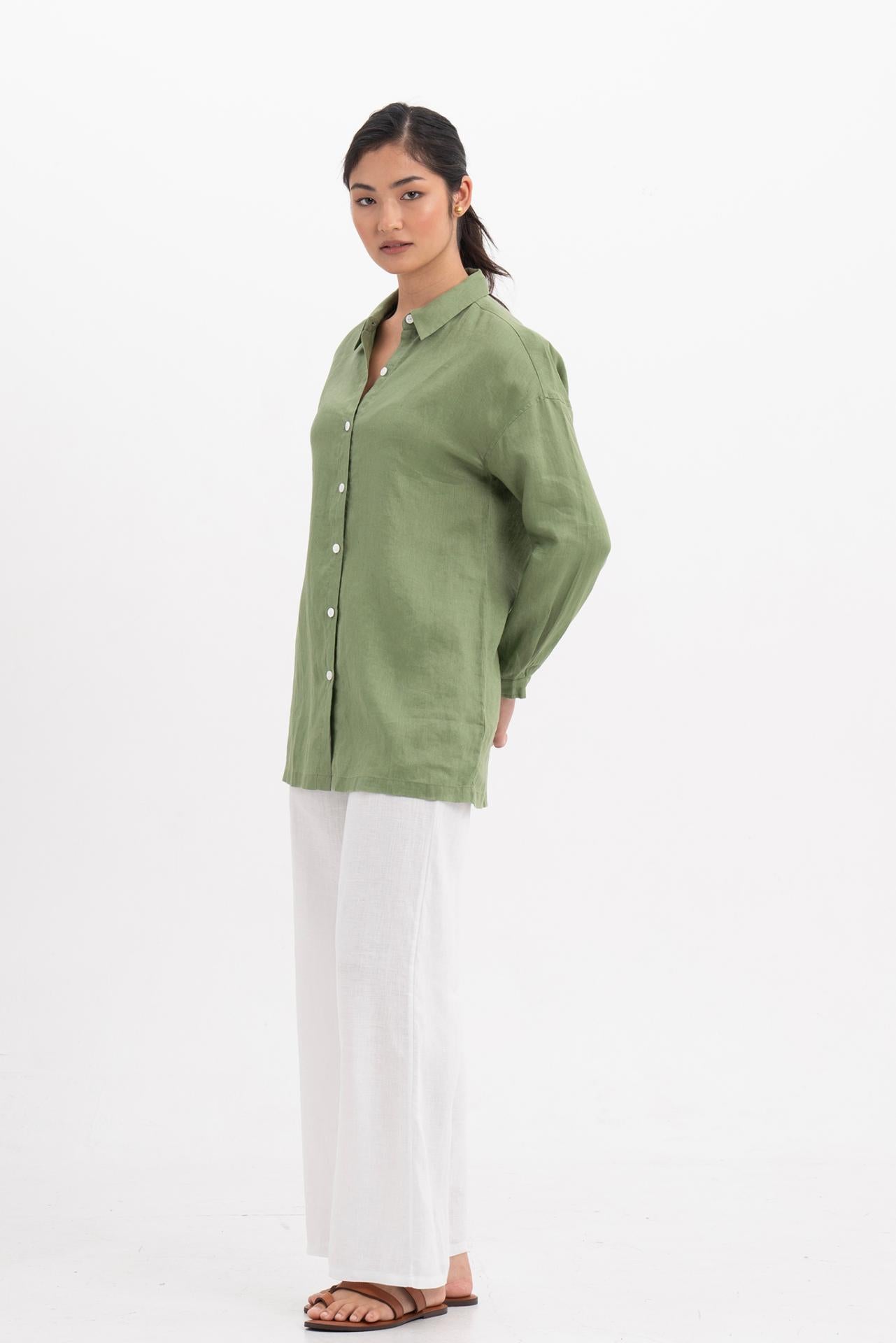 Side profile of the Tifa Linen Shirt Green showing its cut and natural movement.