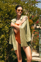 Woman wearing the Tifa Linen Shirt Green designed for effortless resortwear and tropical living by By The Sea Bali.