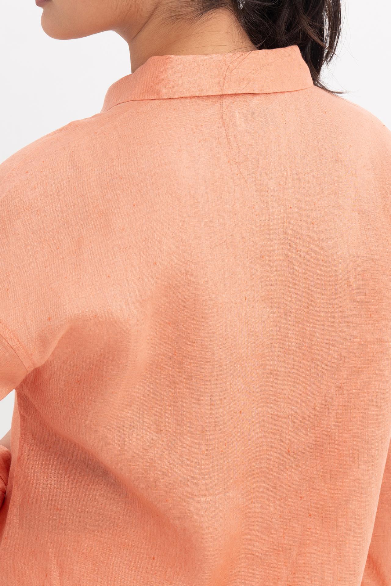Close up back view of the Tifa Linen Shirt Orange highlighting the garment shape and drape.
