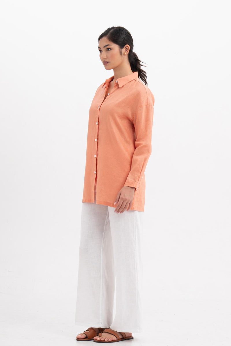 Side profile of the Tifa Linen Shirt Orange showing its cut and natural movement.