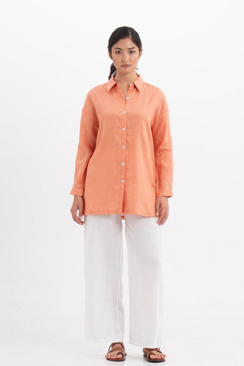 Woman wearing the Tifa Linen Shirt Orange designed for effortless resortwear and tropical living by By The Sea Bali.