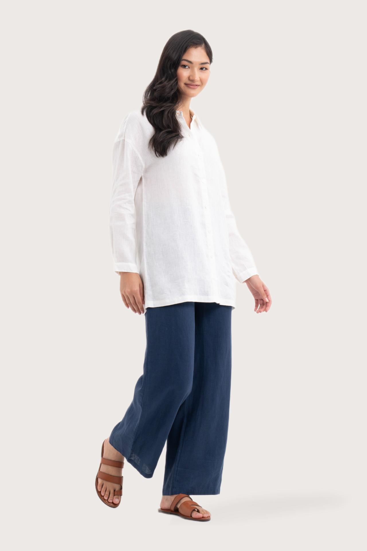 Side profile of the Tifa Linen Shirt White showing its cut and natural movement.