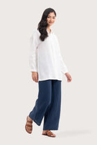 Side profile of the Tifa Linen Shirt White showing its cut and natural movement.