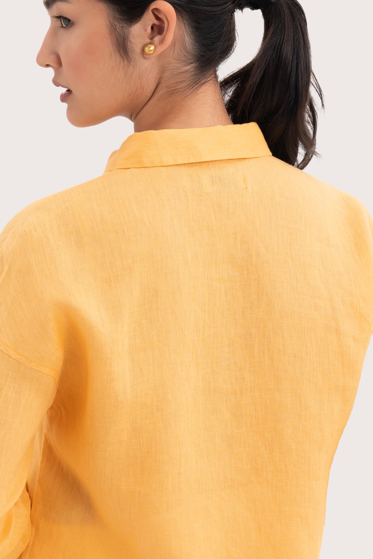 Back view detail of the Tifa Linen Shirt Yellow highlighting the garment shape and drape.