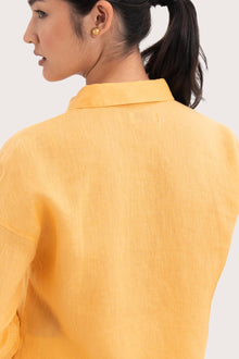 Back view detail of the Tifa Linen Shirt Yellow highlighting the garment shape and drape.