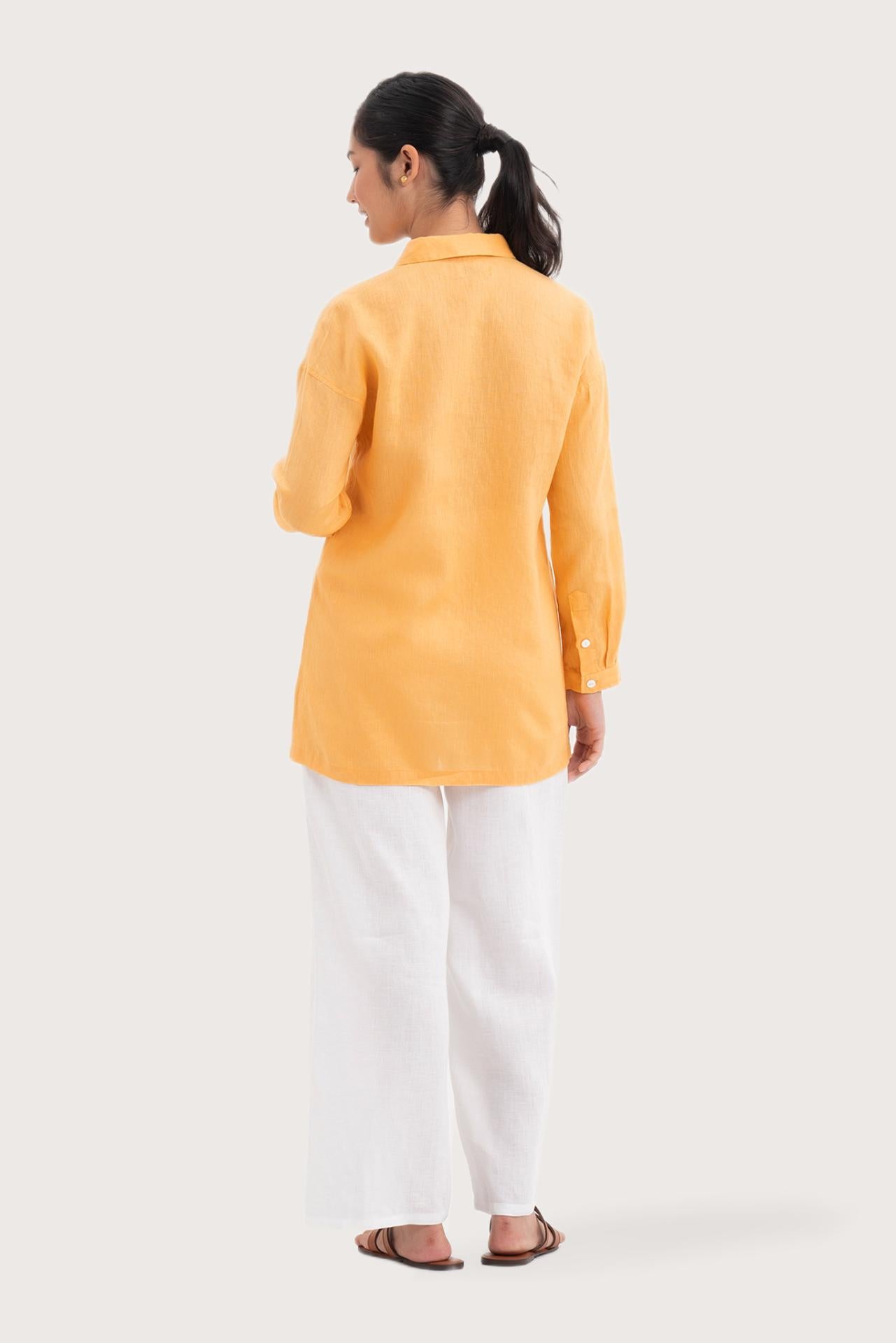Back view of the Tifa Linen Shirt Yellow highlighting the garment shape and drape.