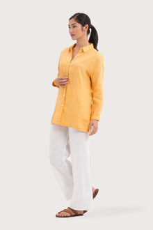 Side profile of the Tifa Linen Shirt Yellow showing its cut and natural movement.