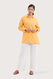 Woman wearing the Tifa Linen Shirt Yellow designed for effortless resortwear and tropical living by By The Sea Bali.