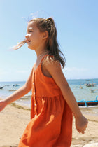 Child wearing Tilly Linen Dress in a natural tropical lifestyle setting