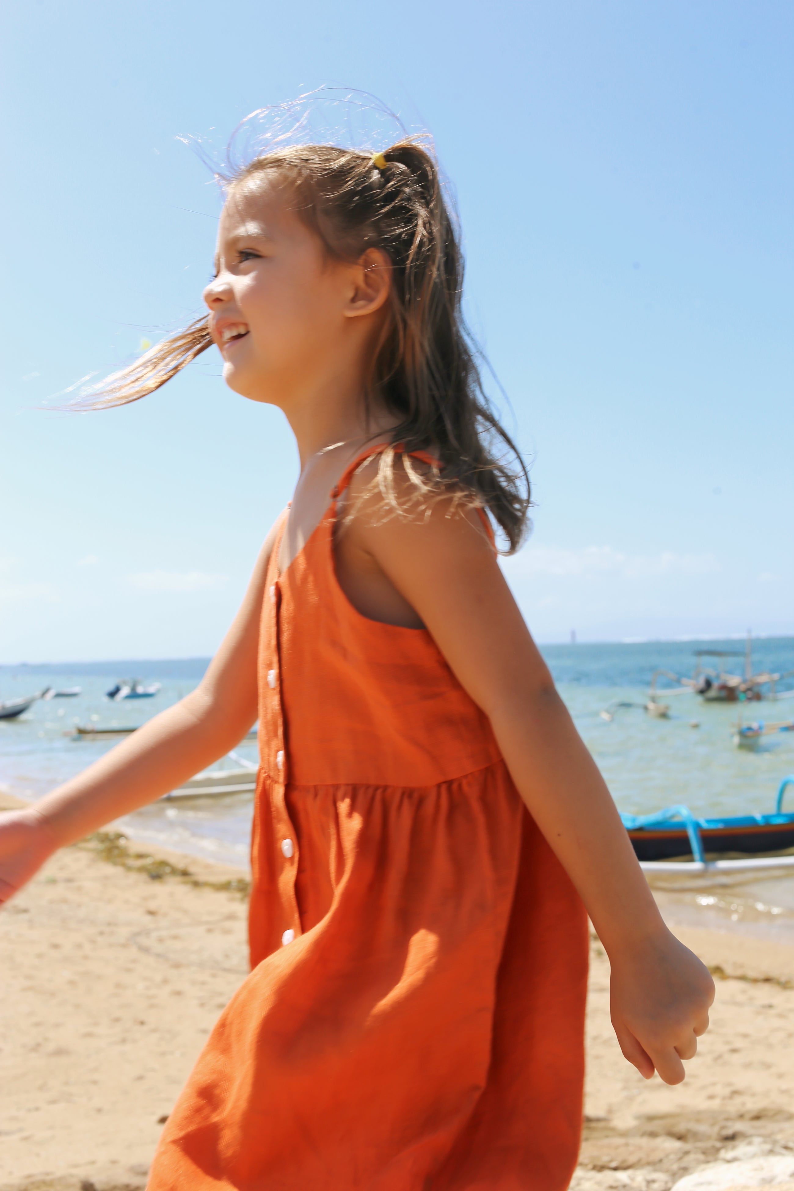 Child wearing Tilly Linen Dress in a natural tropical lifestyle setting