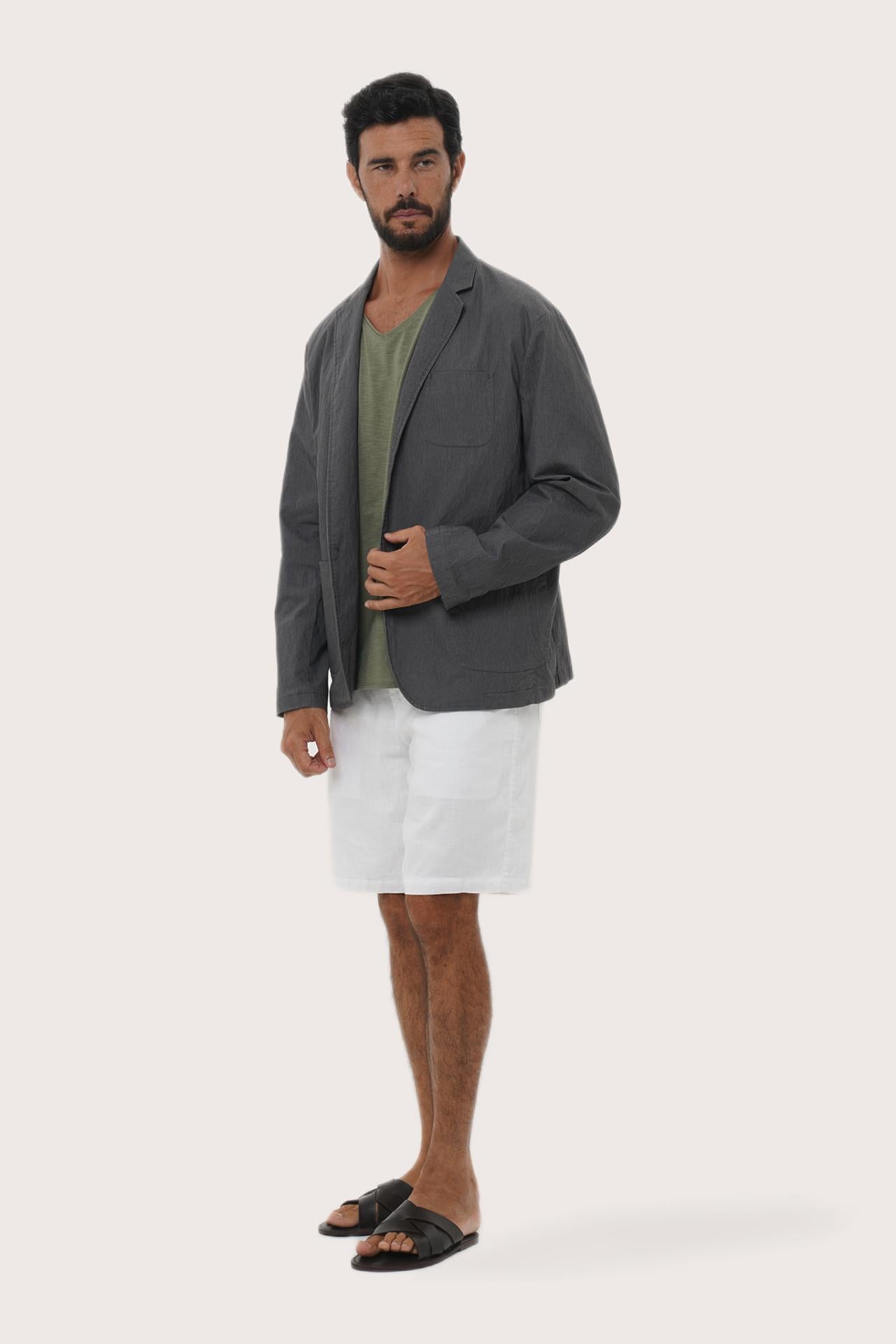 Side profile of the dark grey blazer showcasing its structured fit and refined tailoring