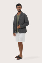 Side profile of the dark grey blazer showcasing its structured fit and refined tailoring