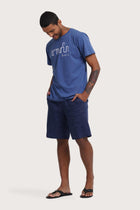 Side profile of the Watu T-shirt Aksara Bali in Indigo by By The Sea Bali – relaxed drape and understated island elegance