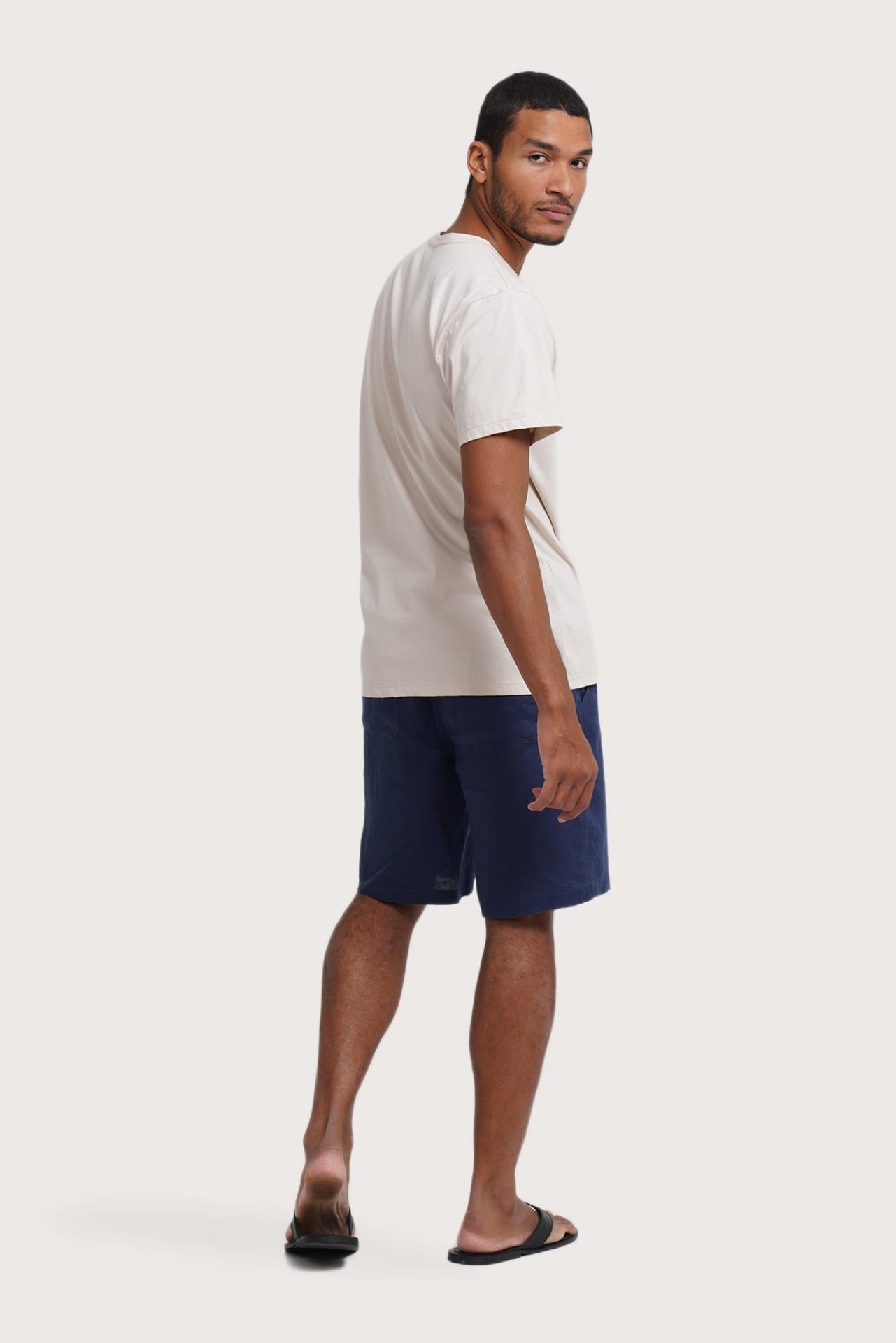 Side profile of the Watu T-shirt Canggu in Cream by By The Sea Bali – relaxed drape and understated island elegance