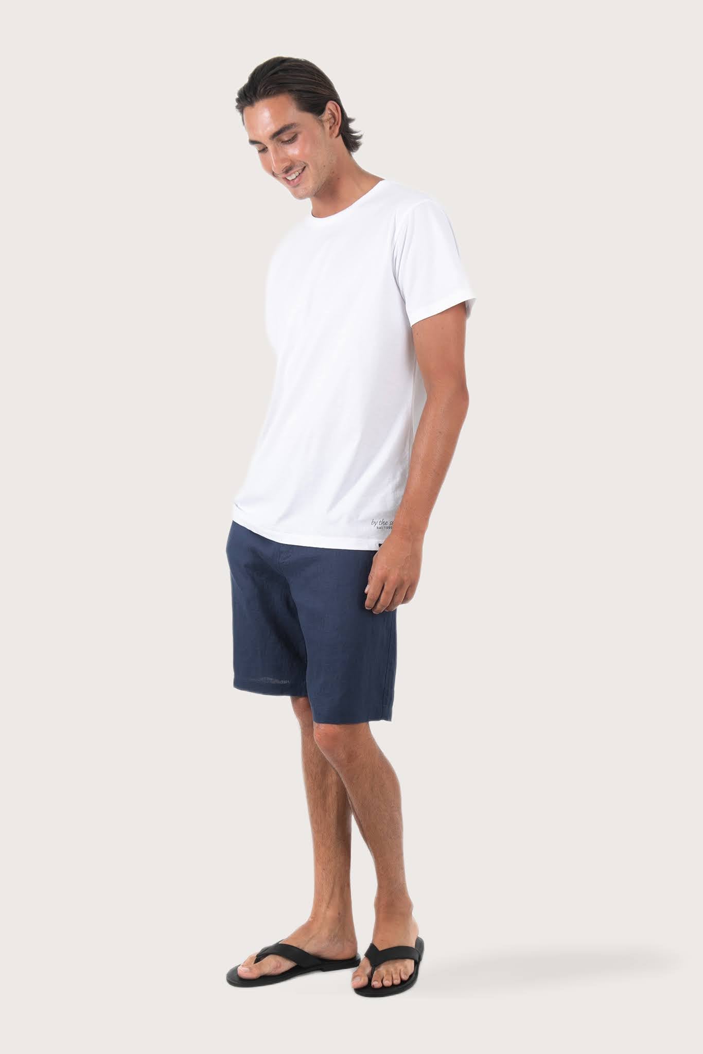 Side profile of the Watu T-shirt Palm Print by By The Sea Bali – relaxed drape and understated island elegance