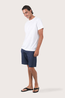 Side profile of the Watu T-shirt Palm Print by By The Sea Bali – relaxed drape and understated island elegance