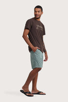 Side profile of the Watu T-shirt Uluwatu in Brown by By The Sea Bali – relaxed drape and understated island elegance