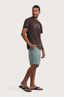 Side profile of the Watu T-shirt Uluwatu in Brown by By The Sea Bali – relaxed drape and understated island elegance