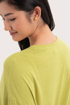 Back view details of the Yara Top Lime highlighting the garment shape and drape.