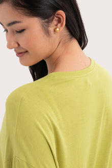 Back view details of the Yara Top Lime highlighting the garment shape and drape.