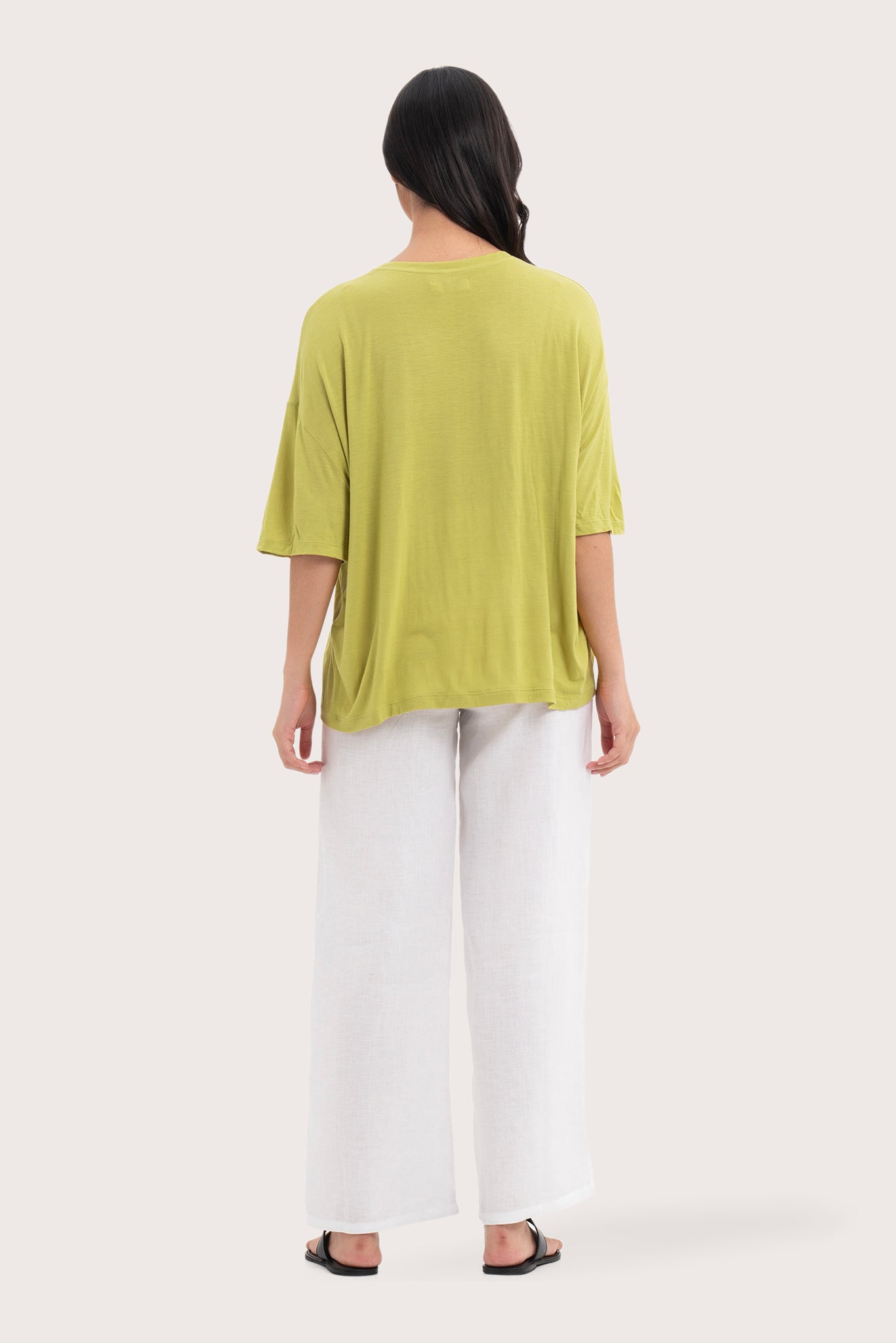 Back view of the Yara Top Lime highlighting the garment shape and drape.