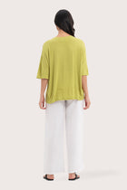 Back view of the Yara Top Lime highlighting the garment shape and drape.