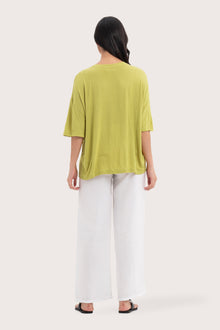 Back view of the Yara Top Lime highlighting the garment shape and drape.