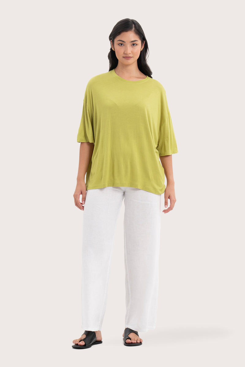 Front view of the Yara Top Lime showcasing its silhouette and relaxed fit.
