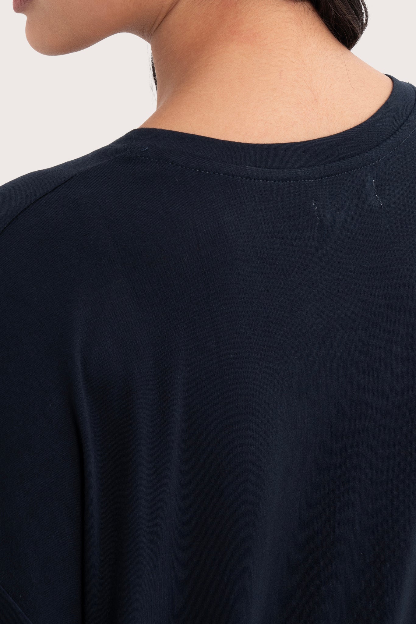 Back view details of the Yara Top Navy highlighting the garment shape and drape.