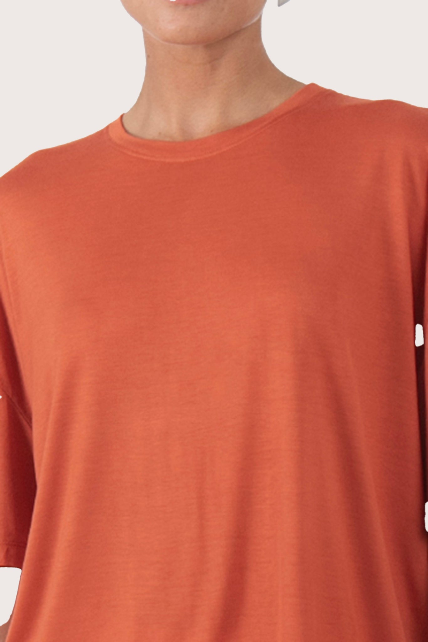 Close up front of the Yara Top Orange highlighting craftsmanship and design features.